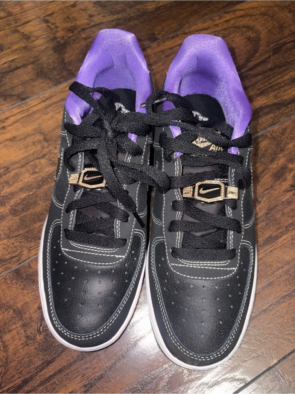 Nike Women’s Black Sneakers with Purple Lining and Gold Accents
